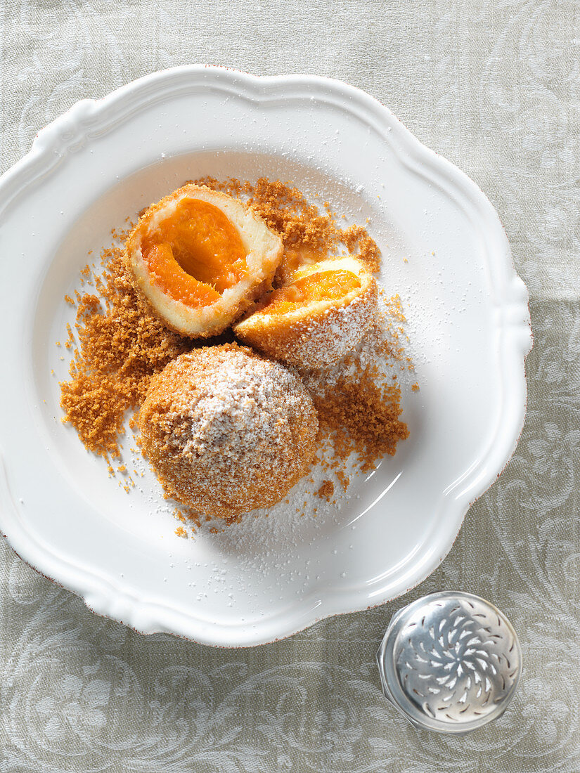 Apricot dumplings with icing sugar