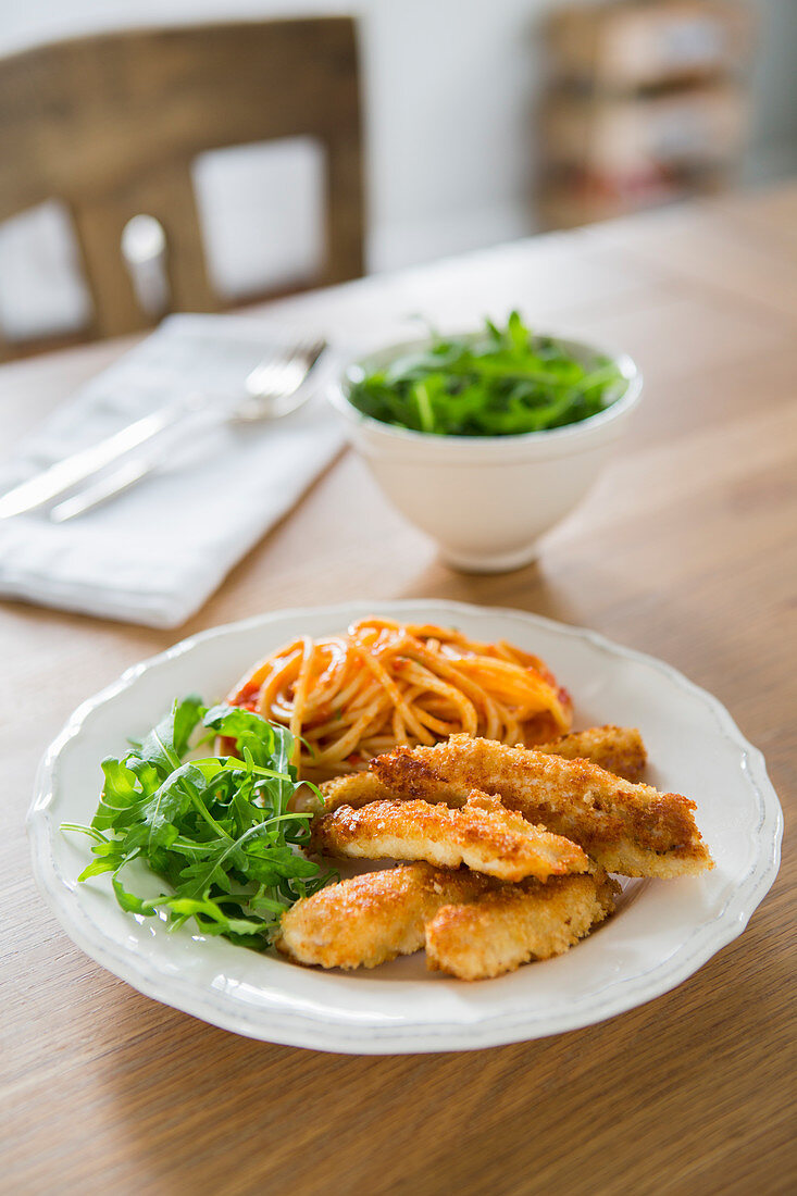 Chicken schnitzel strips with tomato spaghetti