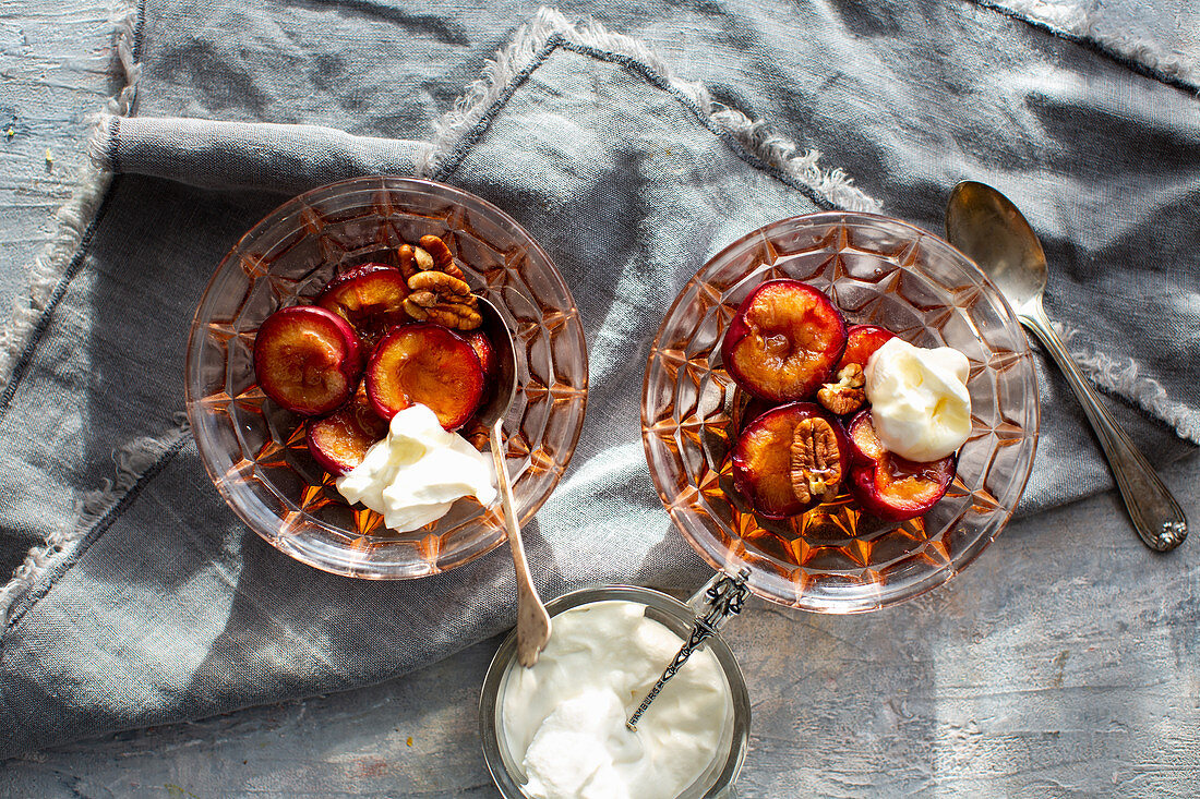 Honey plums with pecan nuts and cream