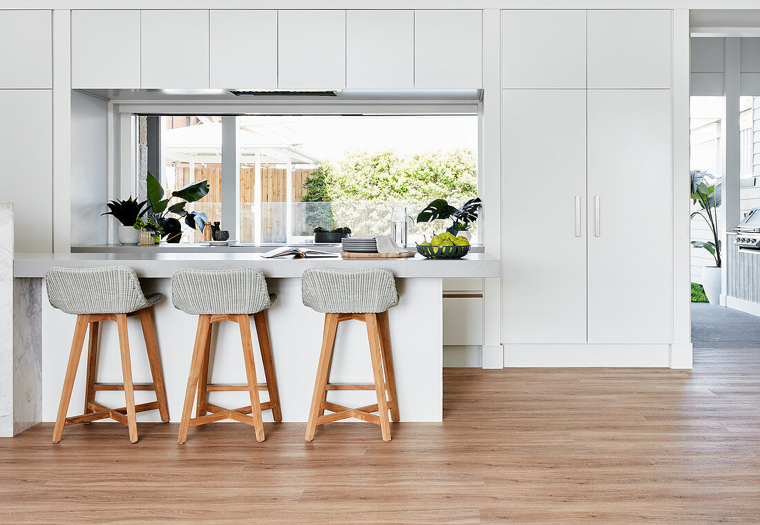 Fitted cupboards and counter in white, minimalist kitchen