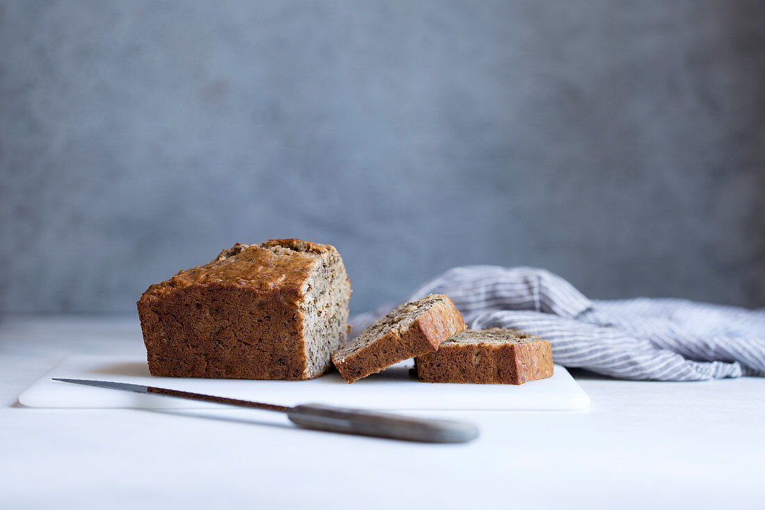 Banana bread, a piece cut against a gray background
