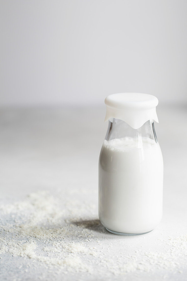 Homemade coconut milk in a small glass bottle
