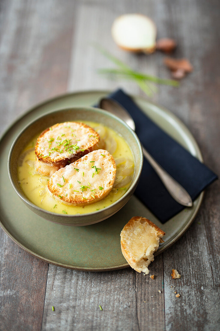 Onion soup with cheese crostini and chives