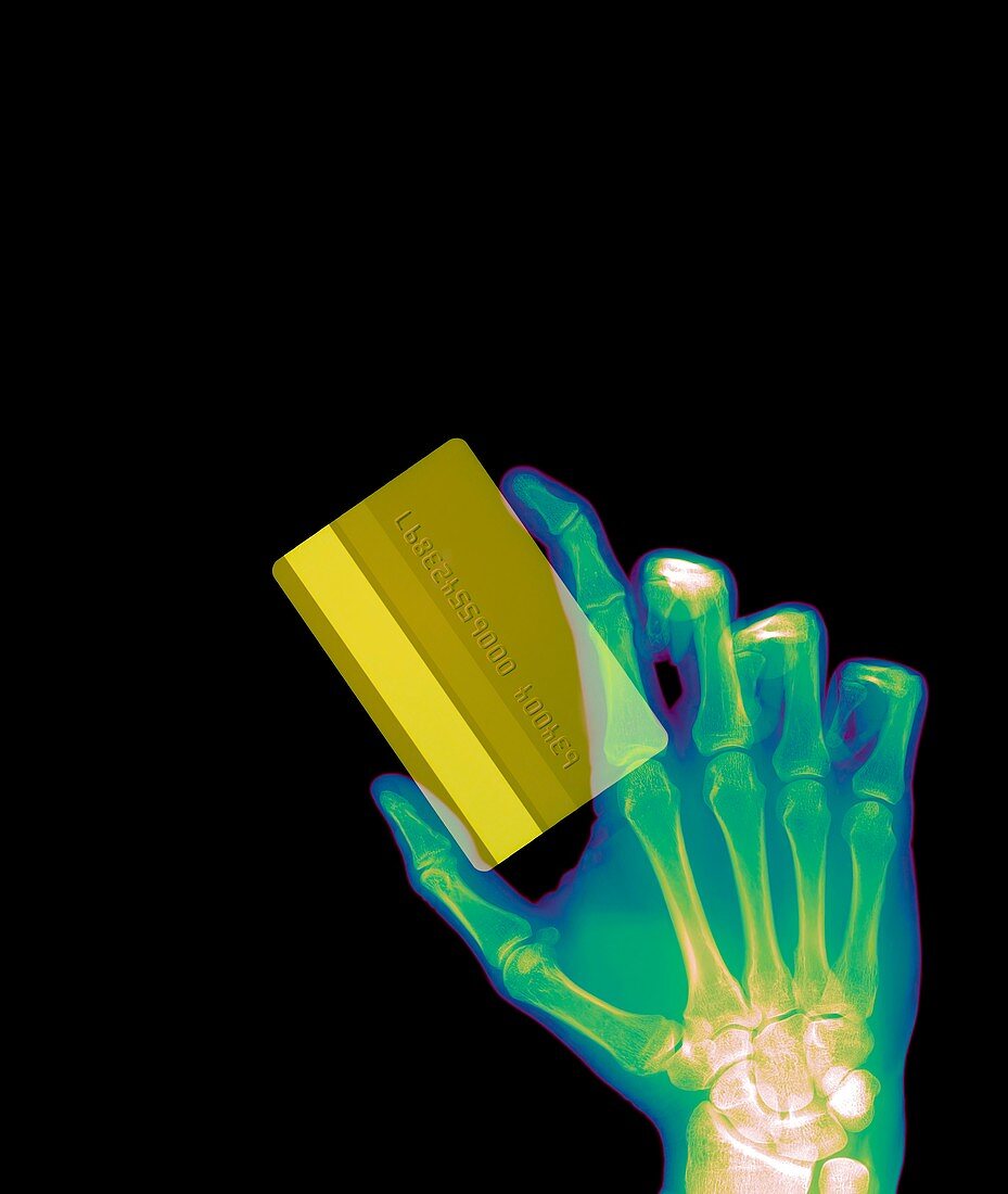 Hand holding credit card, X-ray