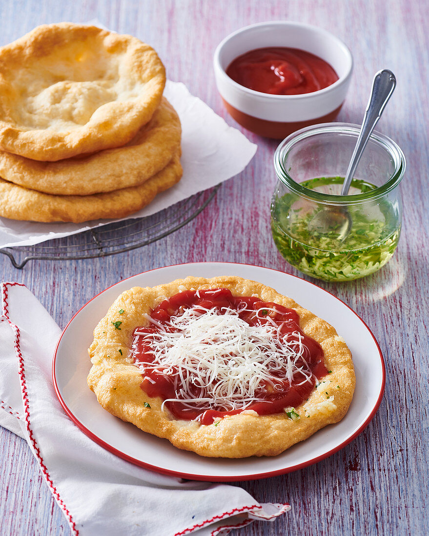 Hungarian Lángos with ketchup and cheese