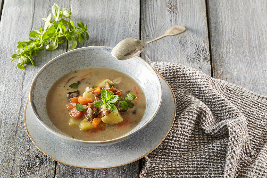 Potato soup with carrots and mushrooms