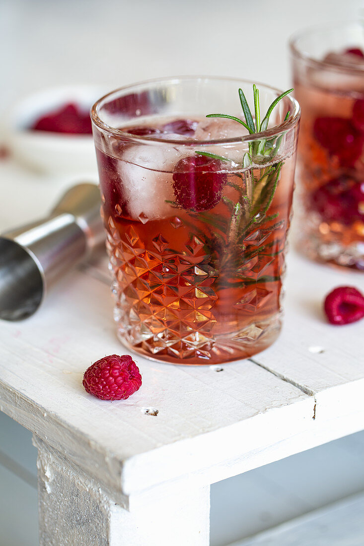 Gin & Tonic with raspberries and rosemary