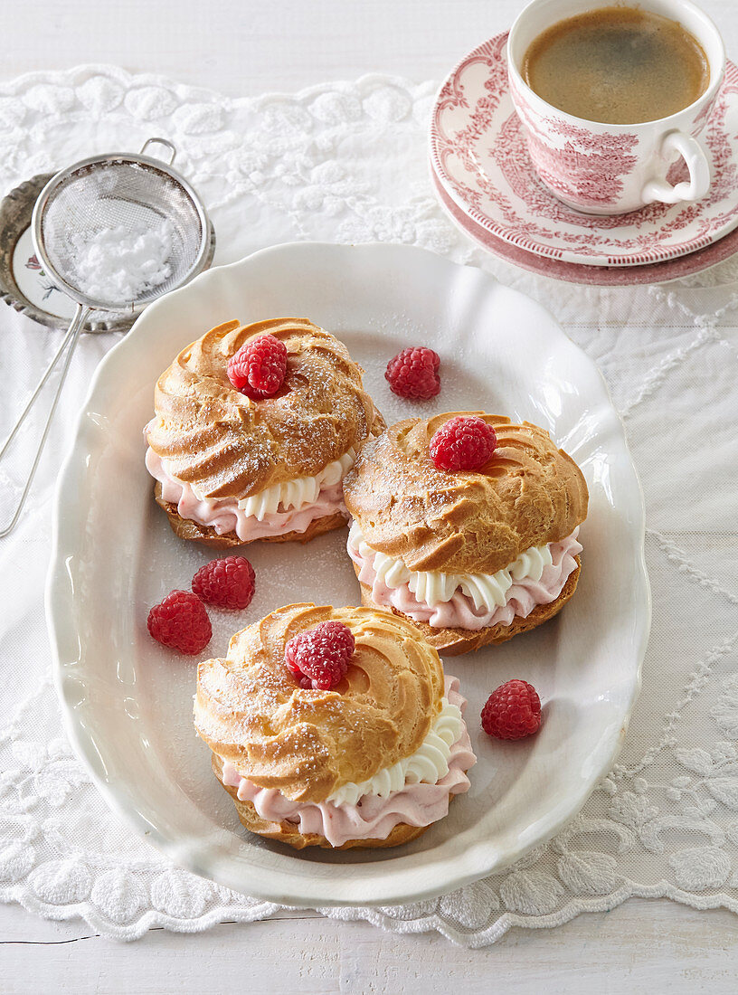 Profiteroles with raspberry cream and whipped cream