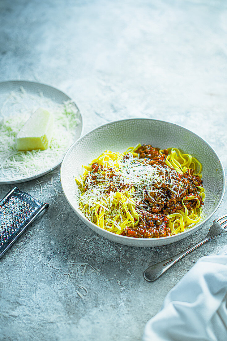 Vegeterian ragu saucemade with tomatoes, lentils, onions, served with pasta and cheese