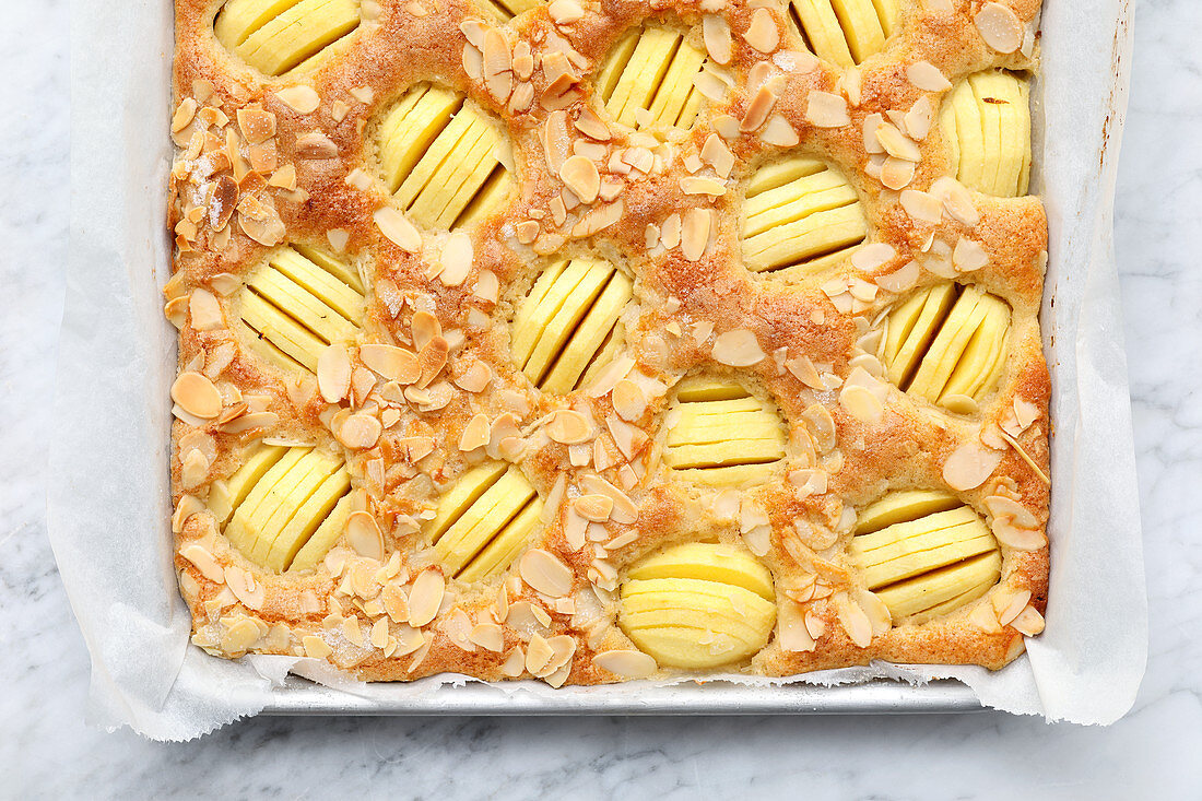 Tray bake apple cake with flaked almonds