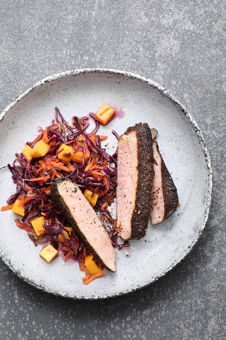 Sous vide pork steaks with a coffee rub served with a red cabbage and mango salad
