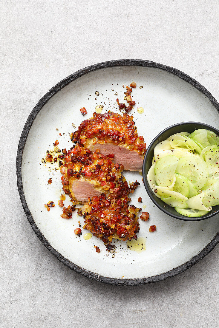 Pork fillet wrapped in bacon with a cucumber salad