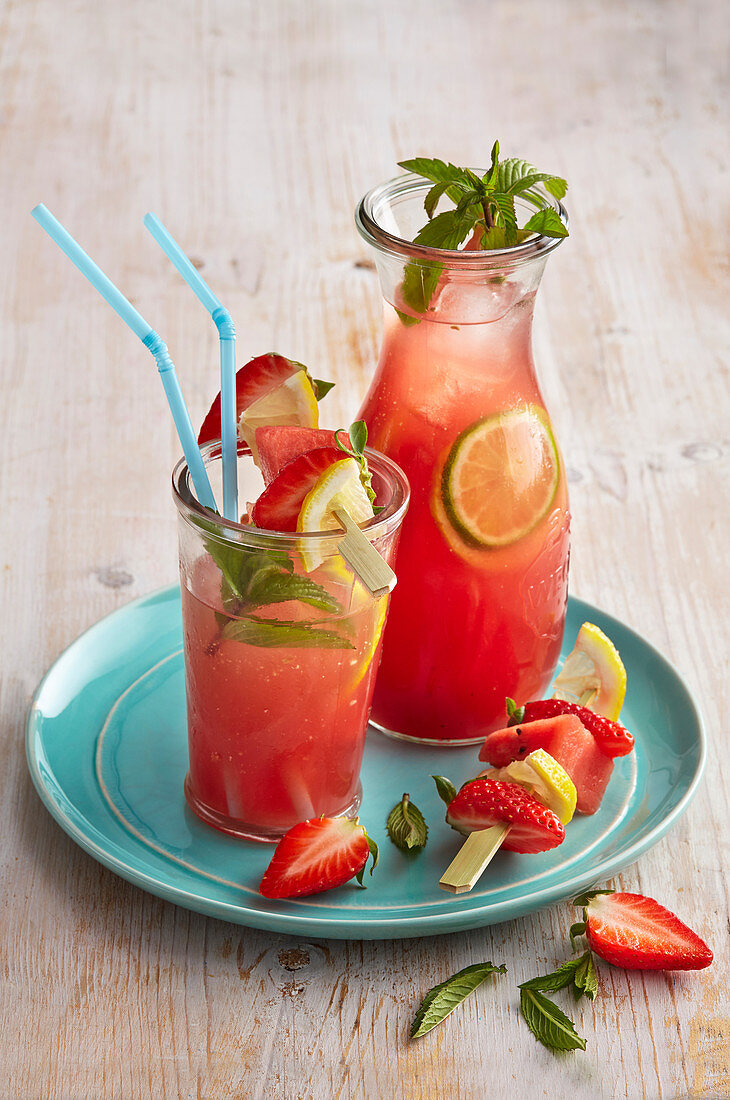 Summer garden drink with strawberries and lemons