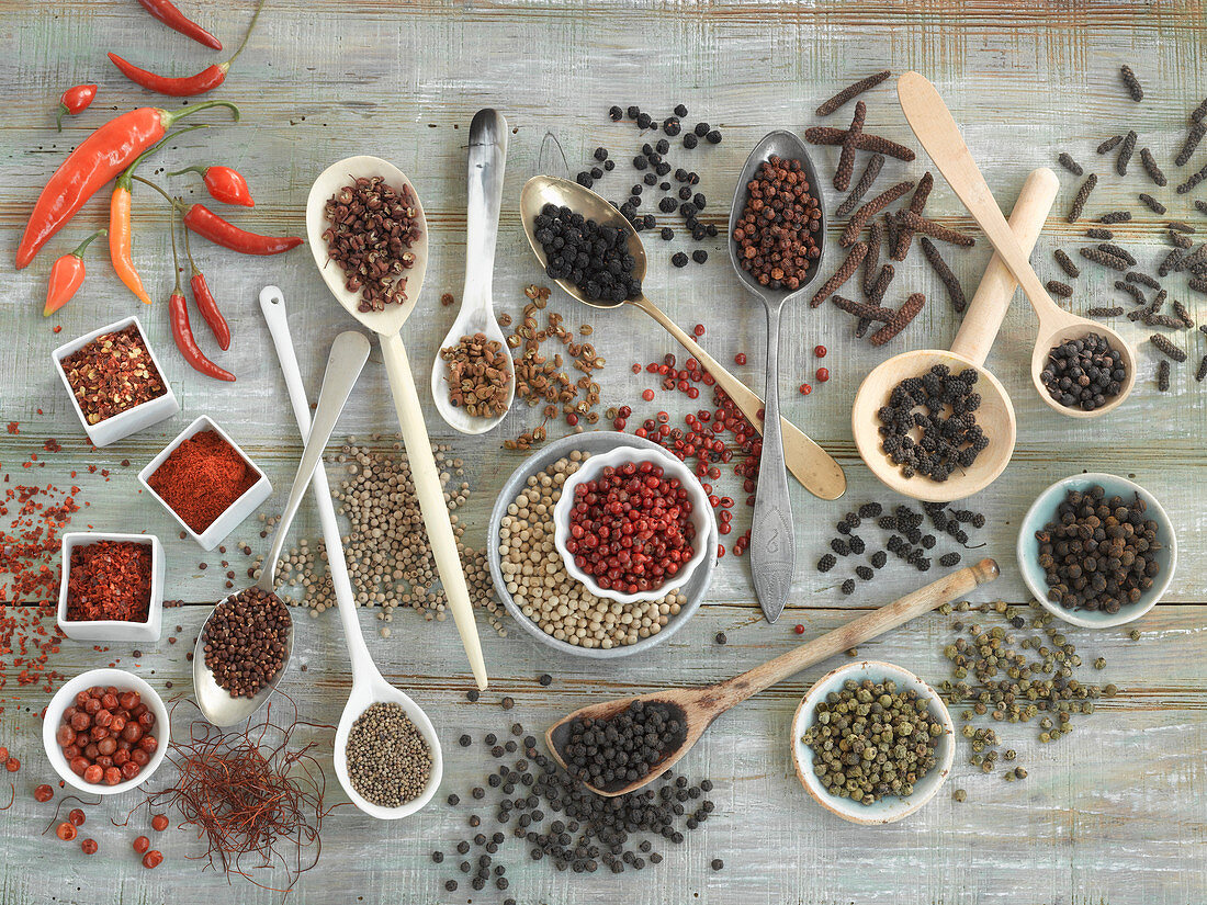 An arrangement of spices with various different types of pepper and chilli