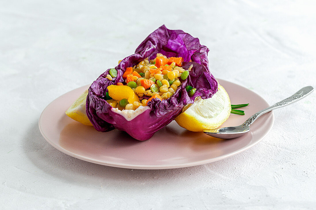 Purple cabbage leaf filled with mix of peppers and lentils