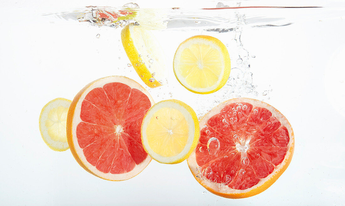 Citrus slices falling into fresh water