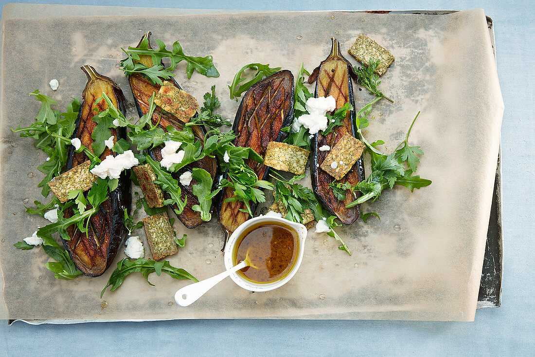Grilled aubergines with herb tofu, dandelions and feta cheese