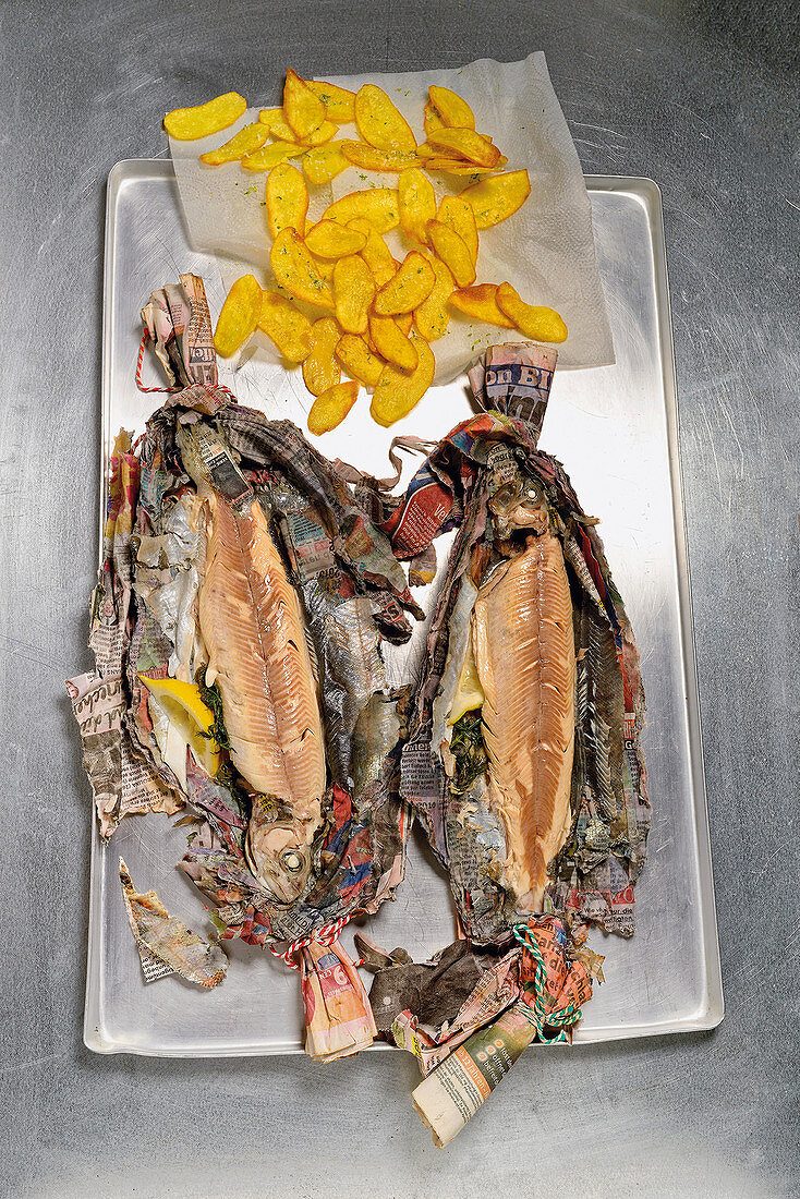 Trout grilled in newspaper with potato chips