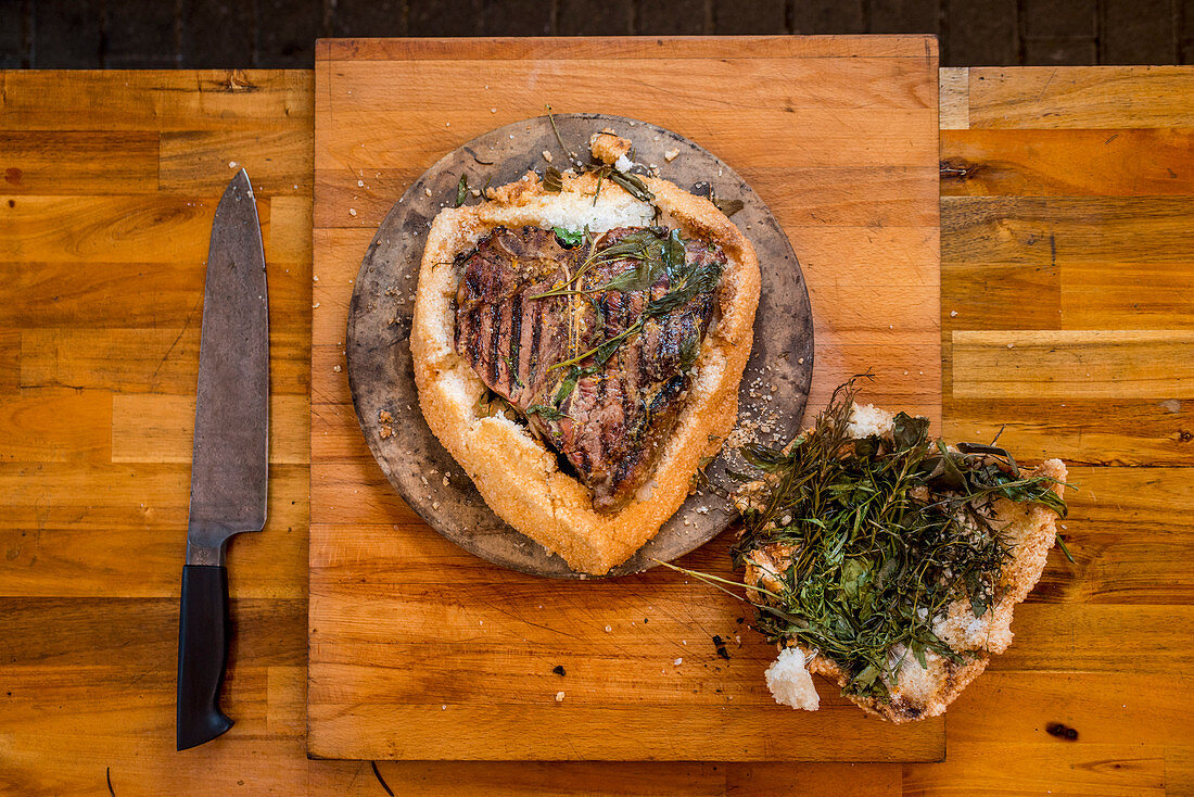 Porterhouse steak grilled in a salt crust