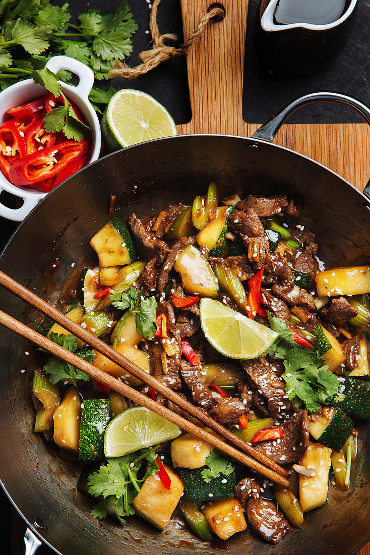 Ooriental spicy stir fry meat with zucchini and red pepper