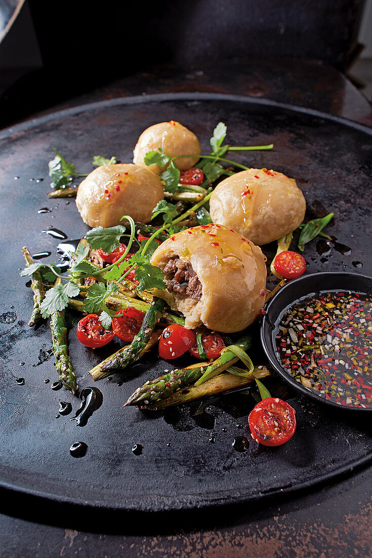 Duck dumplings with asparagus salad and chili sauce