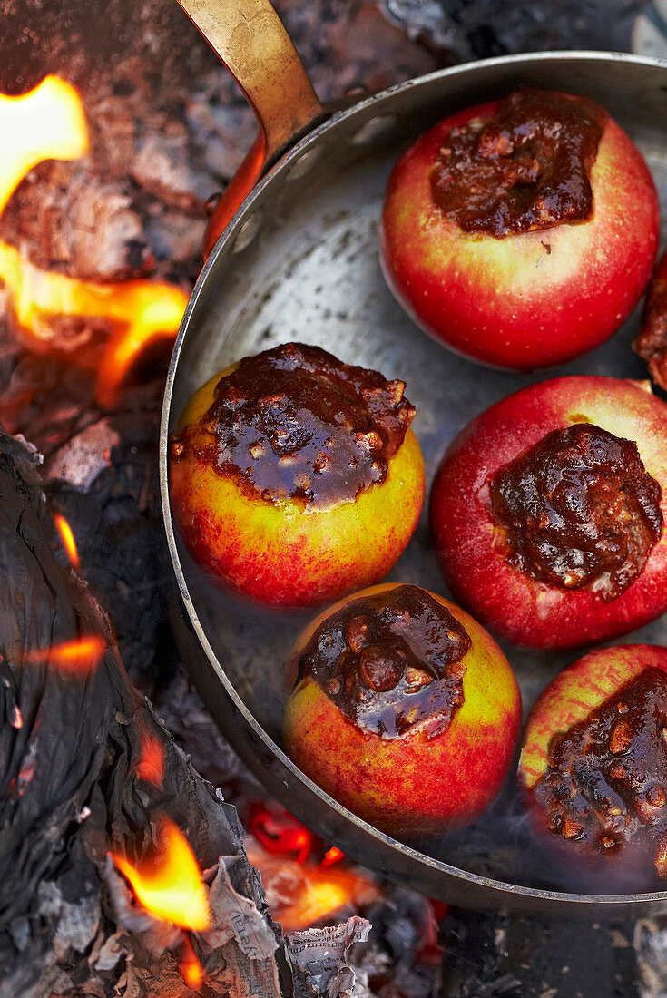 Grilling stuffed apples over a fire