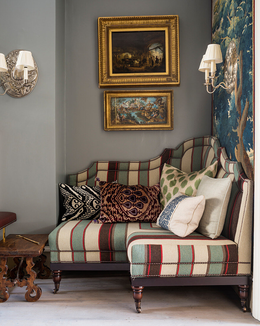 Small, striped corner sofa in niche in classic living room