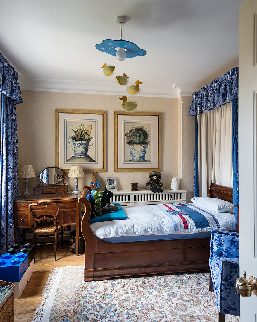 Antique wooden bed and desk in teenager's bedroom with blue accents