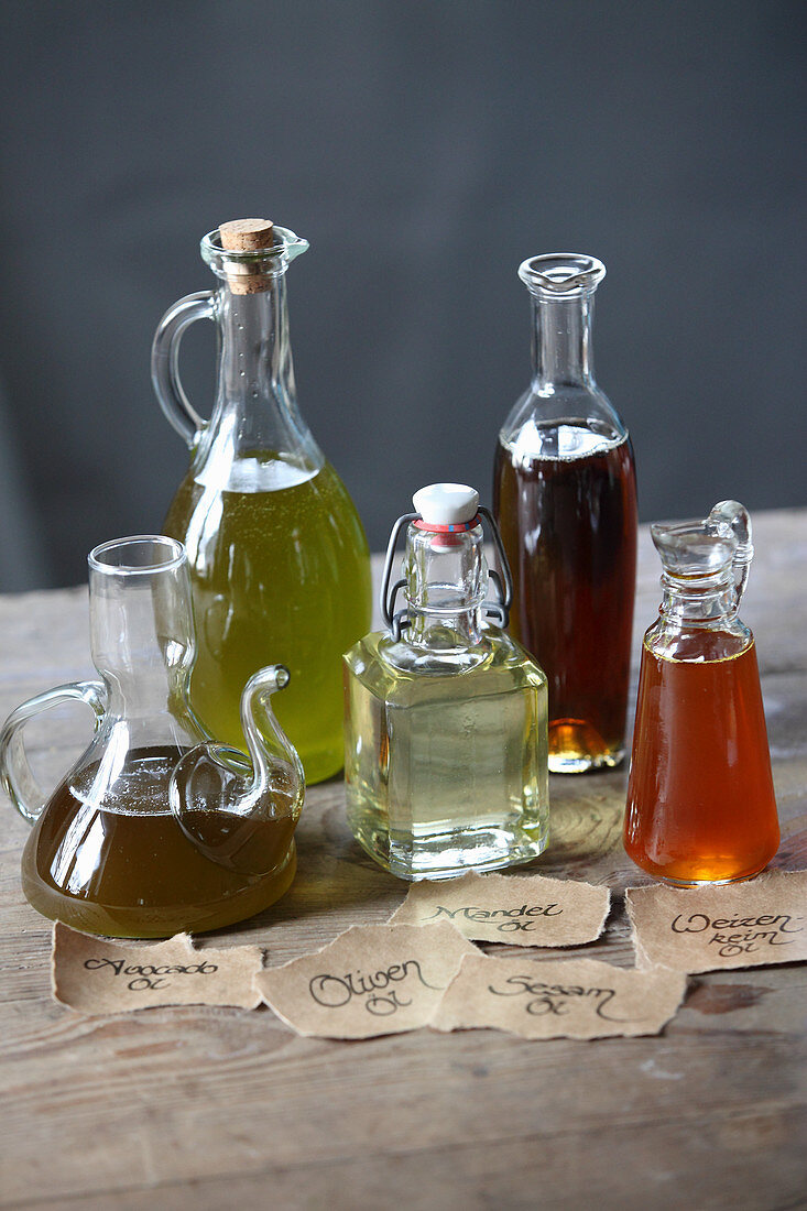 Different oils in glass bottles and carafes