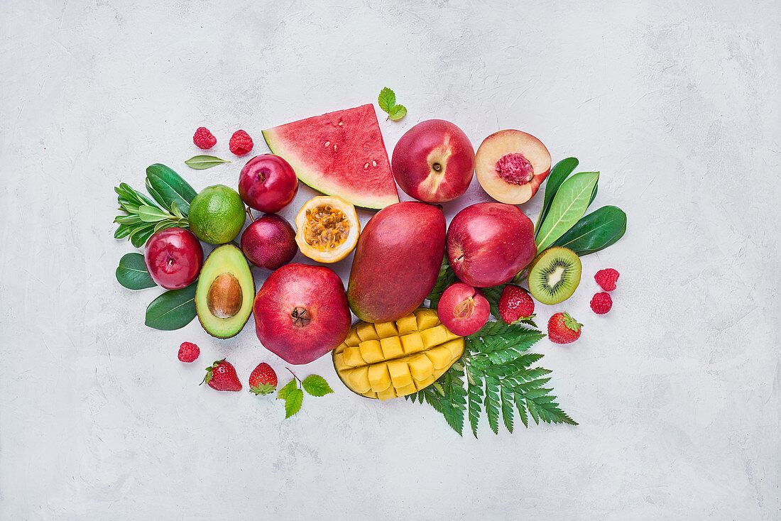 Set of assorted sweet exotic fruits and berries arranged on table