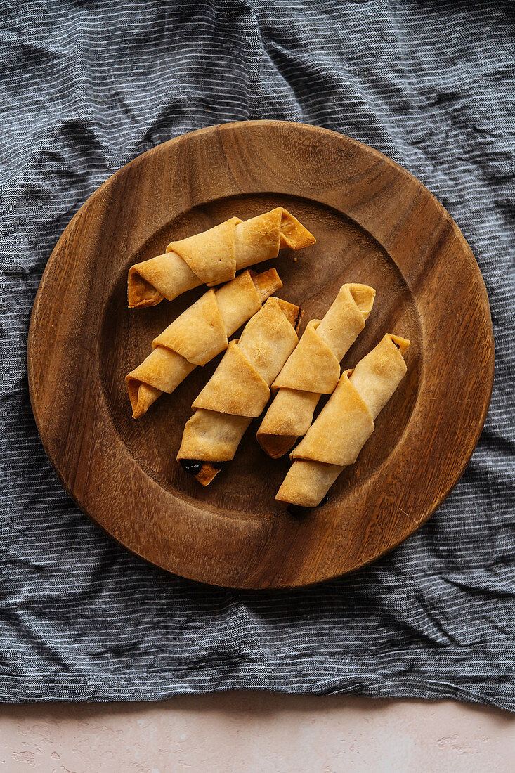Crunchy appetizing croissants in wooden plate