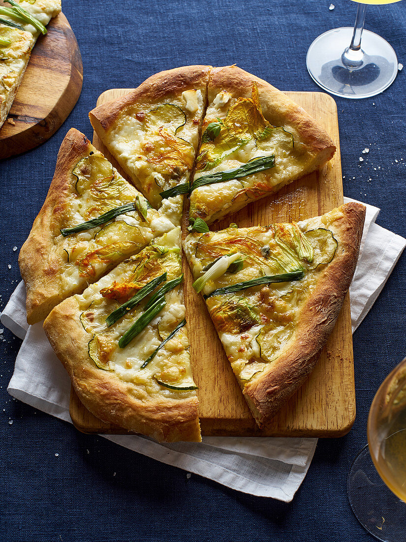 Vegetarian pizza with zucchini flowers, onion, courgette and cheese