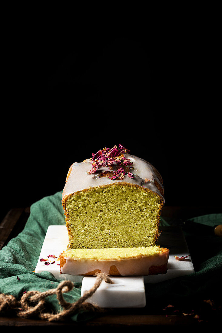 Homemade cake with glaze and flower petals