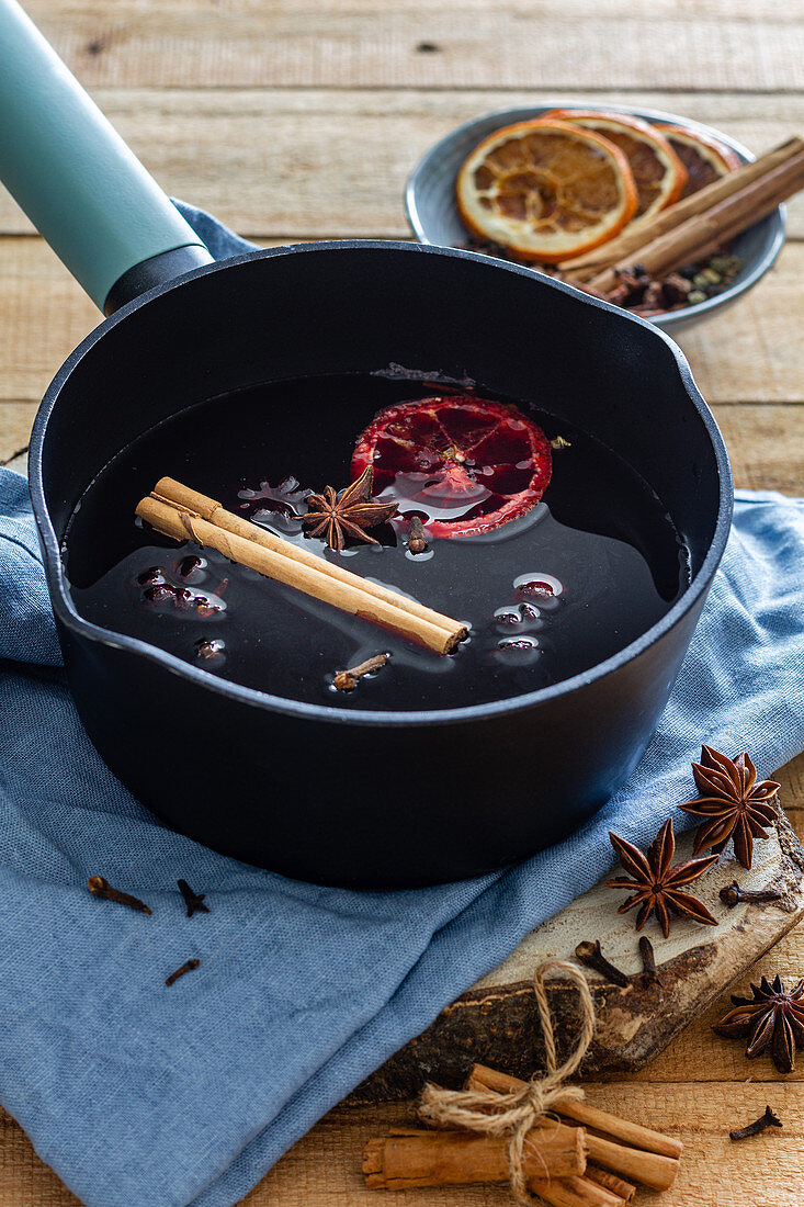 Mulled wine with cinnamon stick and dried oranges