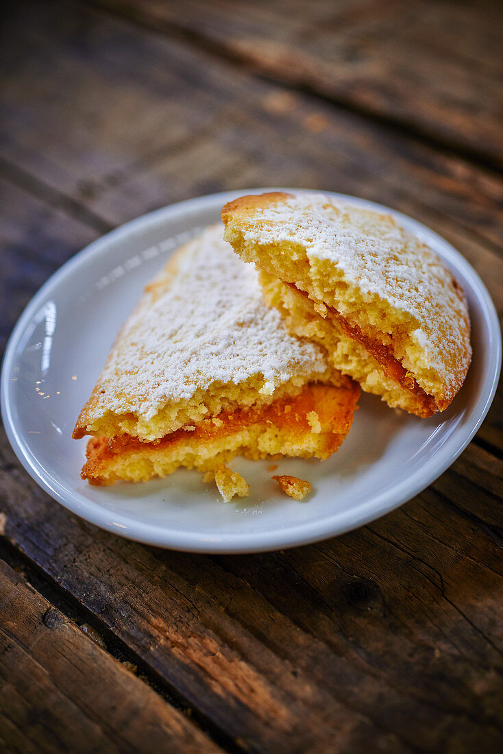 Sponge cakes with orange filling and powdered sugar