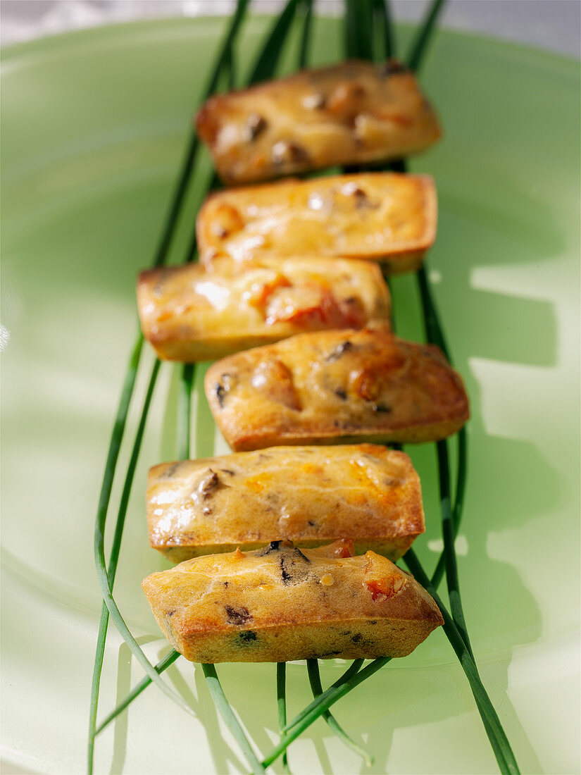 Savory financiers (French cakes) with olives and tomatoes