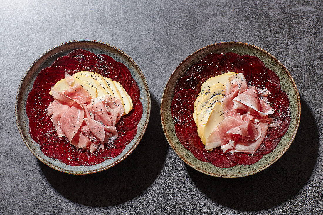 Beetroot carpaccio with scamorza, smoked ham and poppyseeds