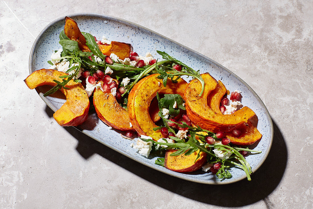 Baked pumpkin with pomegranate and feta cheese