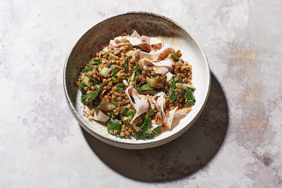 Chard lentil salad with turkey breast slices and a pumpkin seed dressing