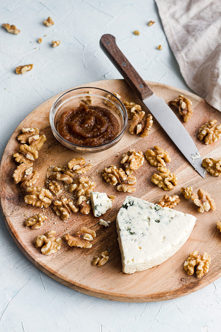 Blue cheese and walnuts on wooden board