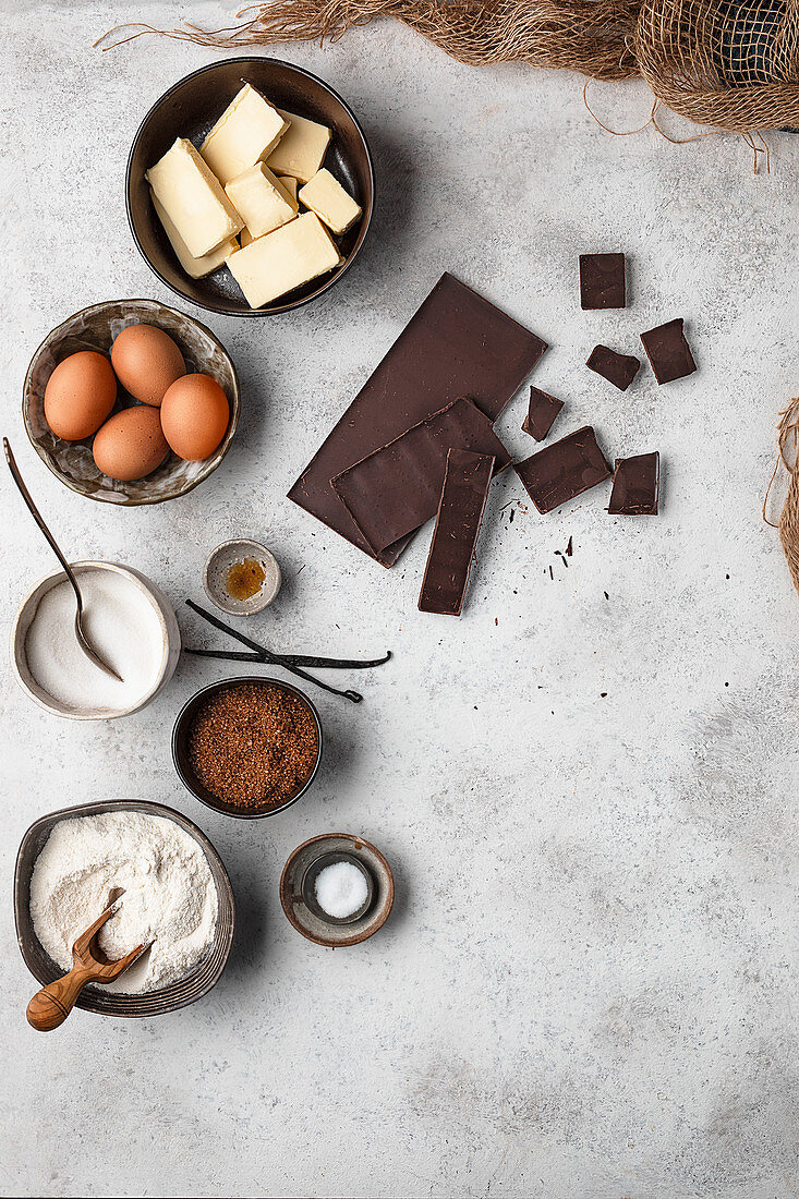 Ingredients for traditional brownie cake on gray marble table