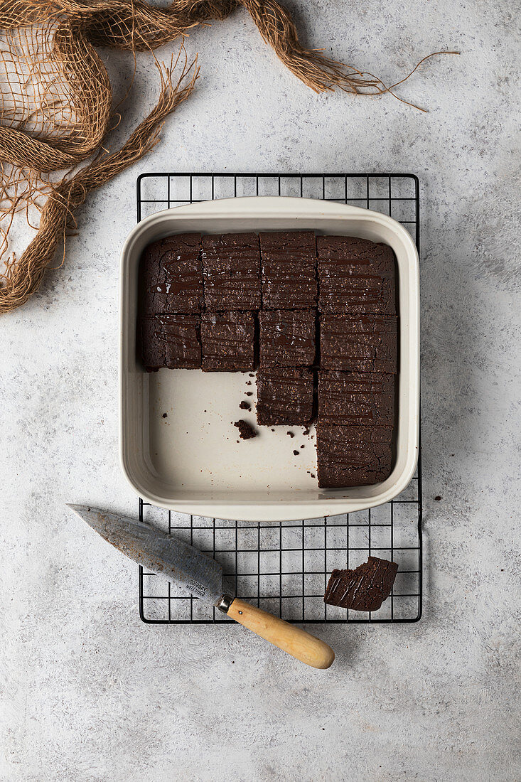 Baking pan with traditional brownie cake cut into pieces