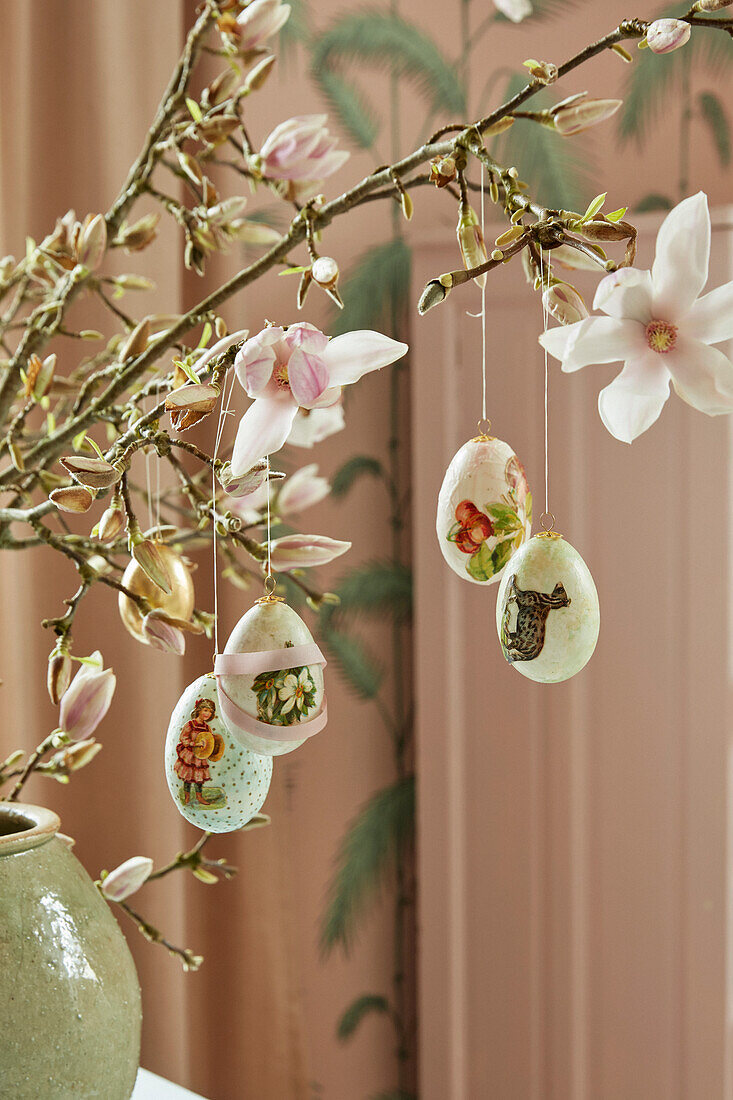 Easter eggs hung from magnolia branches