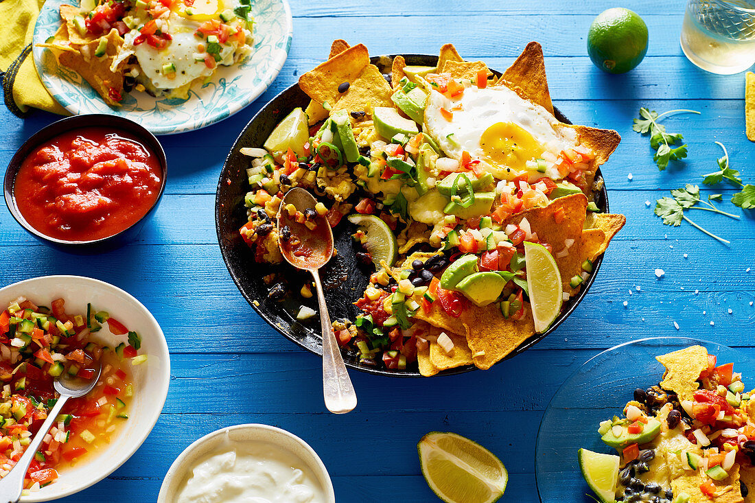 Chilaquiles with black beans, corn, tortilla chips and fried eggs