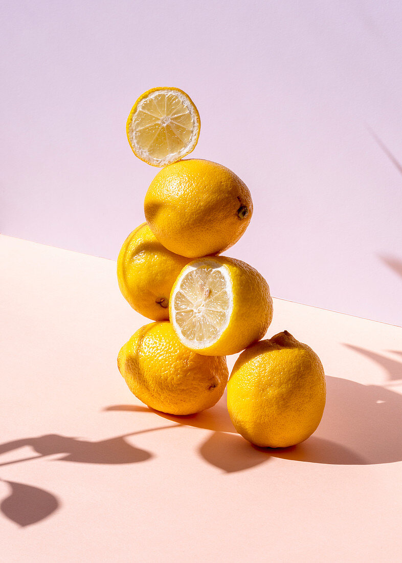 Fresh lemons stacked in shape of pyramid