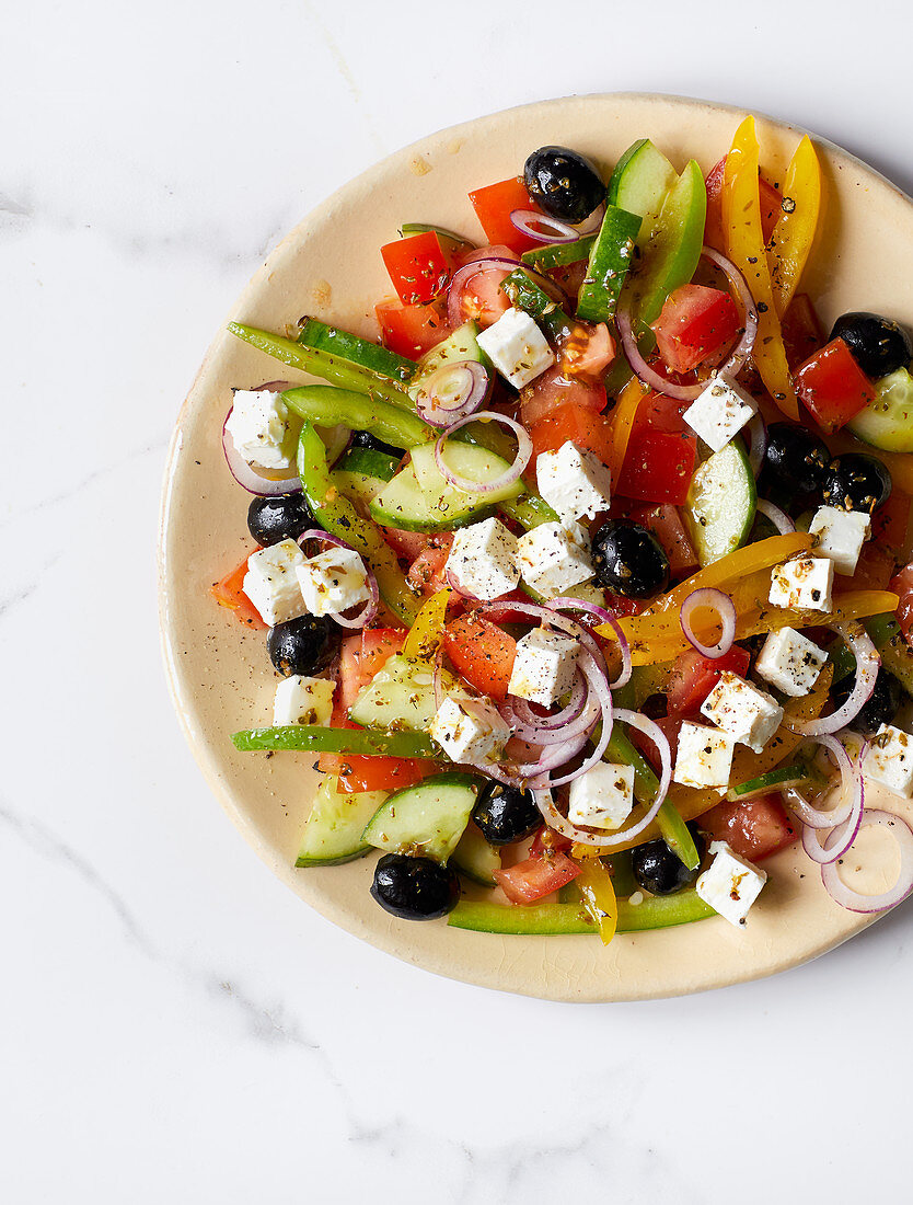 A farmer's salad with feta cheese and black olives