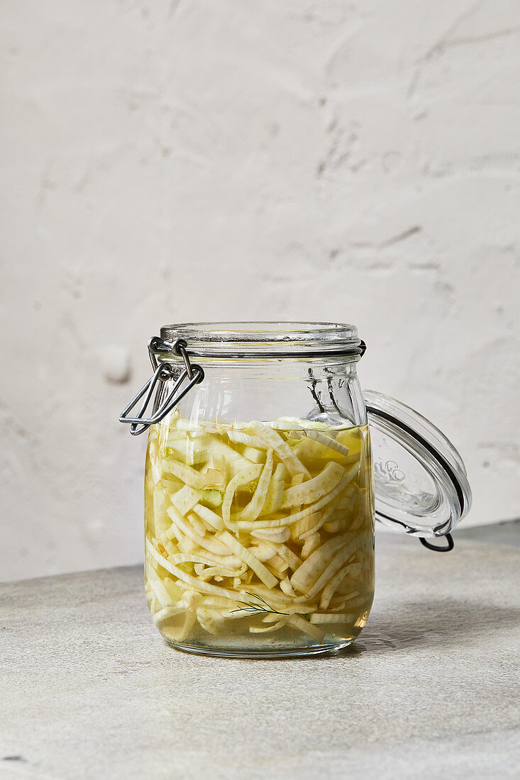 A jar of pickled fennel with pastis