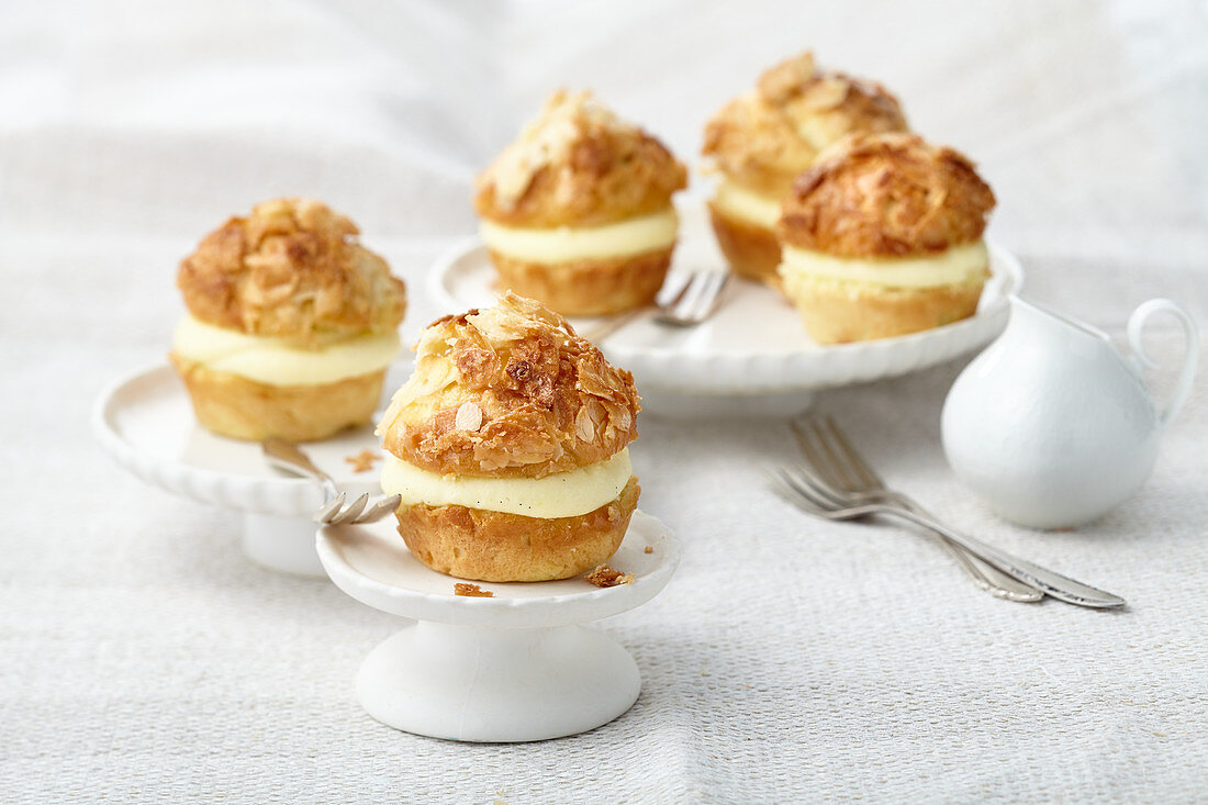 Yeast dough muffins filled with vanilla cream and flaked almonds