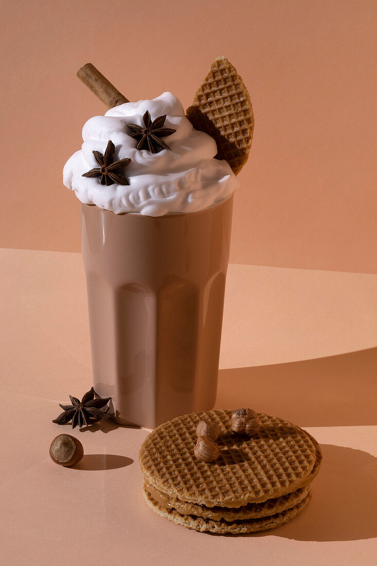Chocolate cocktail with whipped cream, star anise and cinnamon