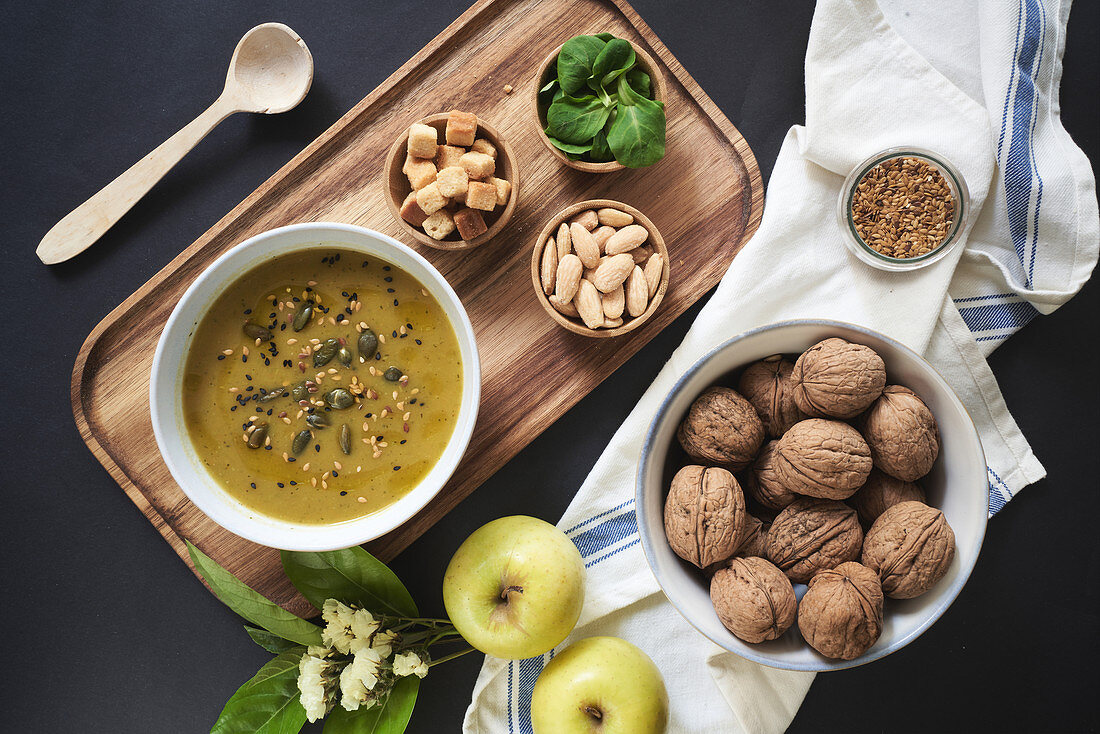 Vegan cream soup with pumpkin seeds , croutons, almonds and basil